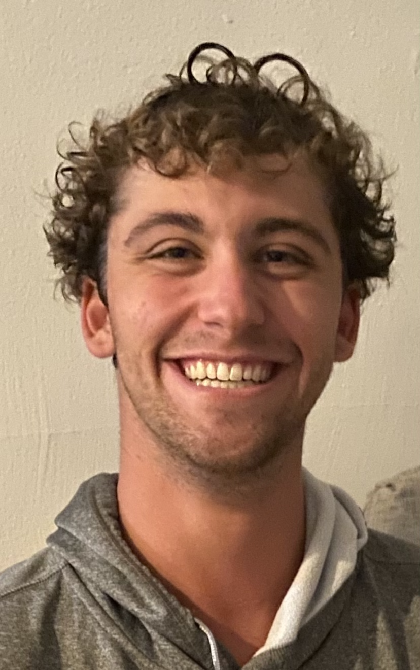 A headshot of Adam Hartmann with a white background